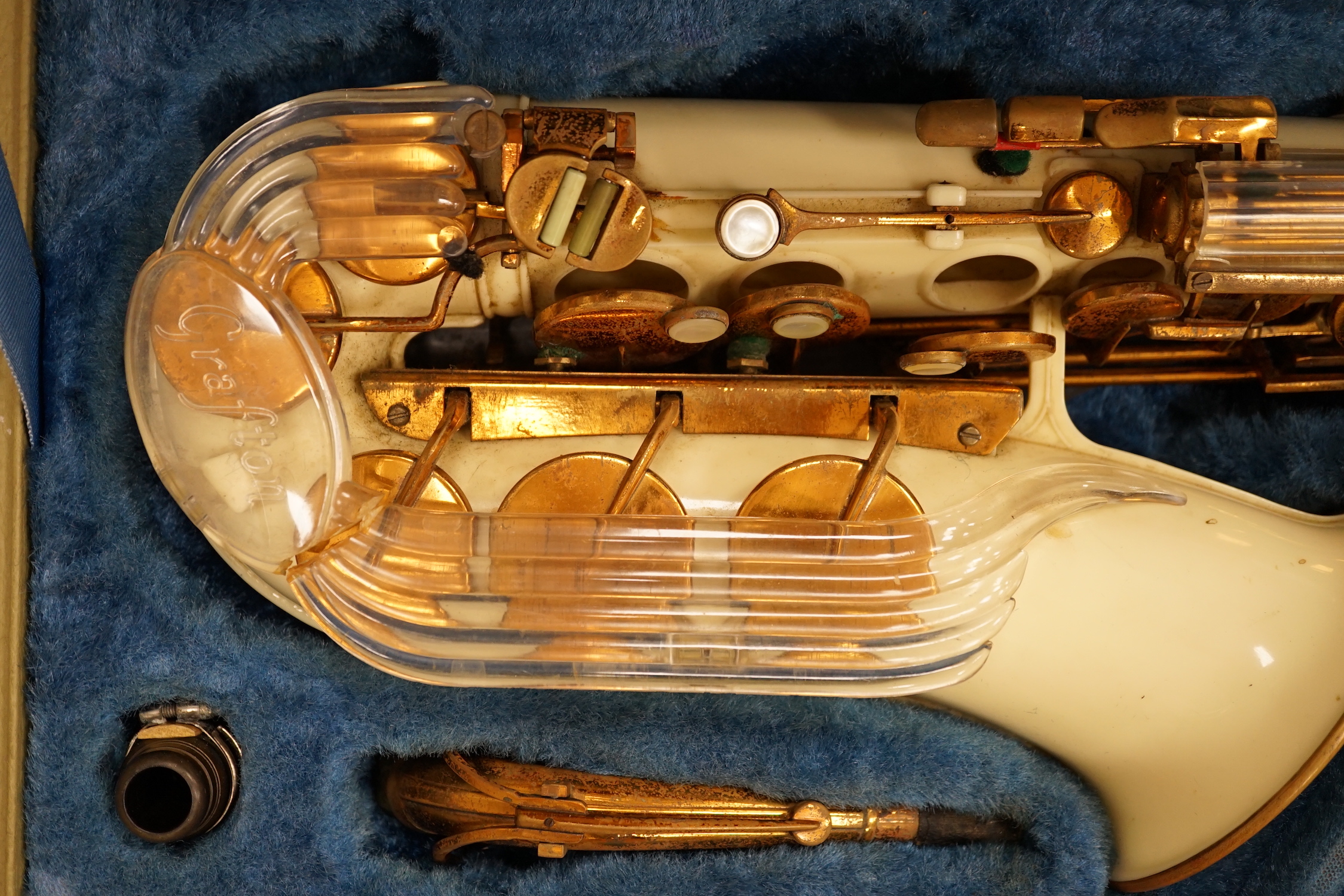 A cased Grafton alto saxophone with cream plastic body and brass plated key work, serial number 13597